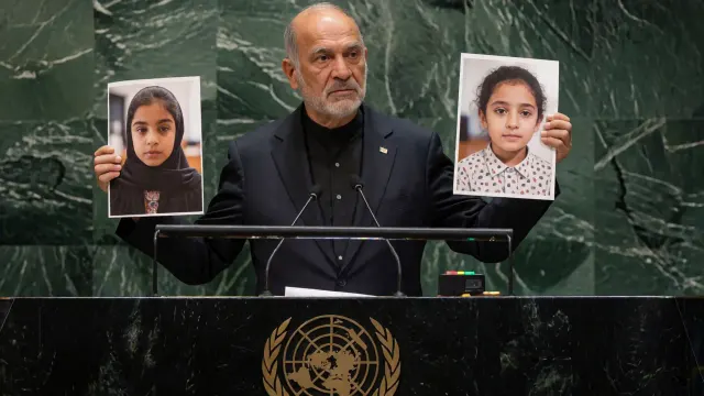 US delegation storms out as Iranian president holds up images of slain children